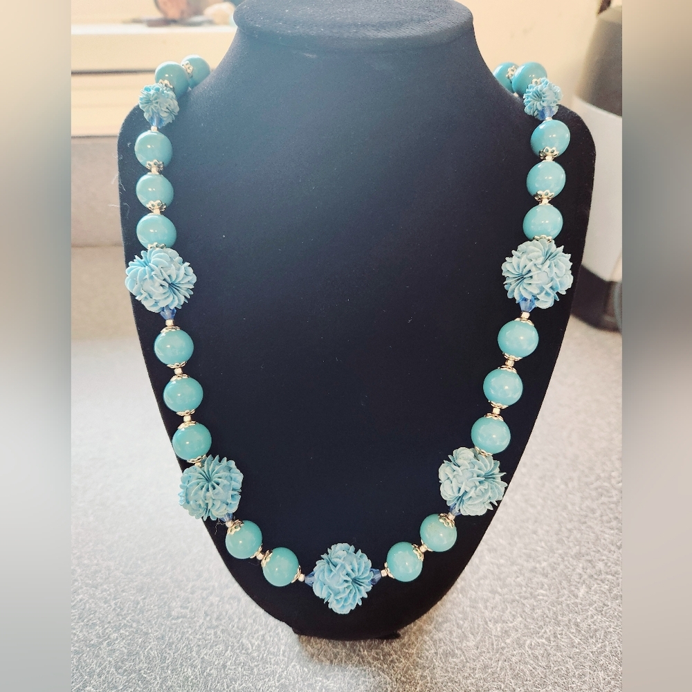 Japan blue graduated necklace with delicate floral designs.